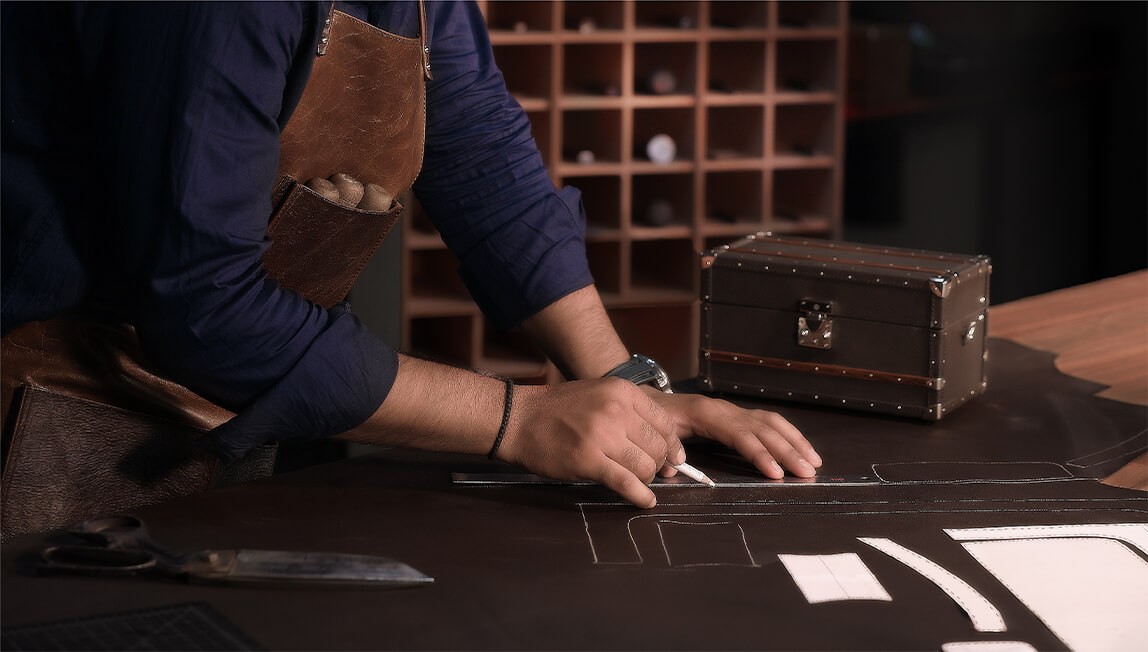Craftsperson handcrafting a bespoke Trunk using traditional leatherworking techniques